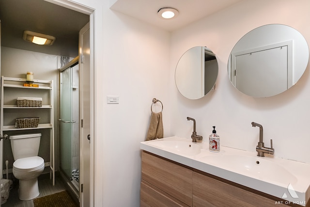 bathroom with tile patterned flooring, vanity, toilet, and a shower with shower door