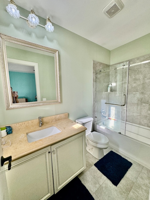 full bathroom featuring vanity, toilet, tile patterned floors, and enclosed tub / shower combo