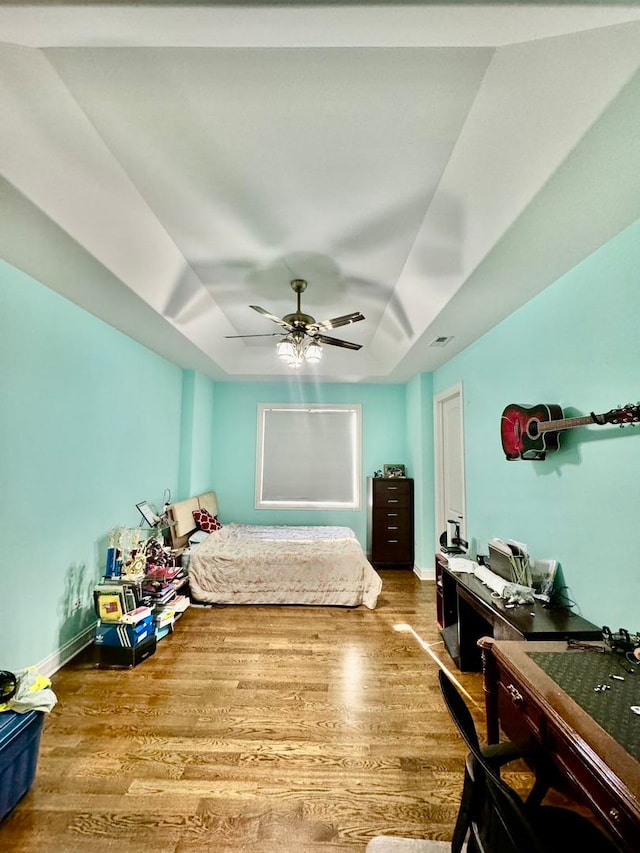 bedroom with ceiling fan and hardwood / wood-style flooring