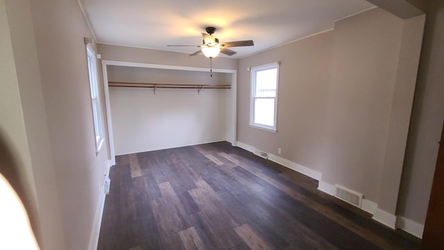 617 E Morgan St, Dixon, IL 61021 - unfurnished bedroom with dark wood finished floors, a closet, baseboards, ceiling fan, and crown molding