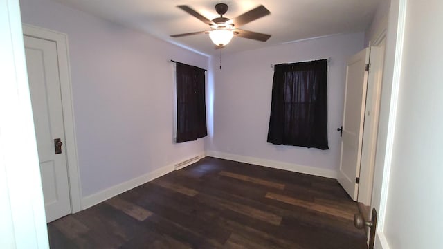 617 E Morgan St, Dixon, IL 61021 - unfurnished room featuring a ceiling fan, dark wood-style floors, and baseboards