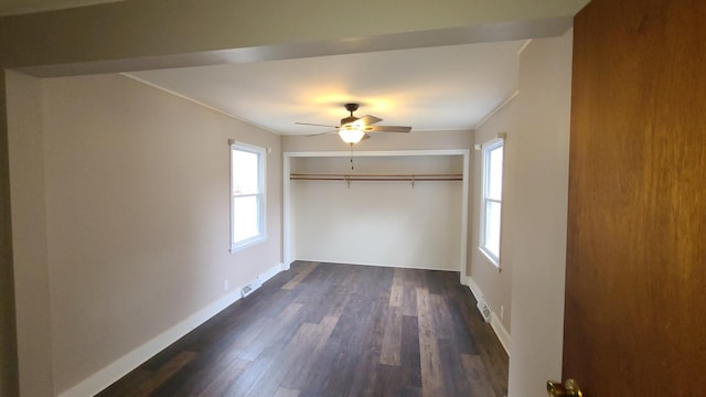 617 E Morgan St, Dixon, IL 61021 - unfurnished bedroom featuring multiple windows, a closet, dark wood-style floors, and baseboards