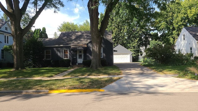 617 E Morgan St, Dixon, IL 61021 - view of front of house with a detached garage, a front yard, and an outbuilding