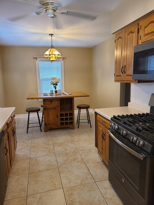 617 E Morgan St, Dixon, IL 61021 - kitchen featuring black appliances, a ceiling fan, light countertops, brown cabinets, and decorative light fixtures
