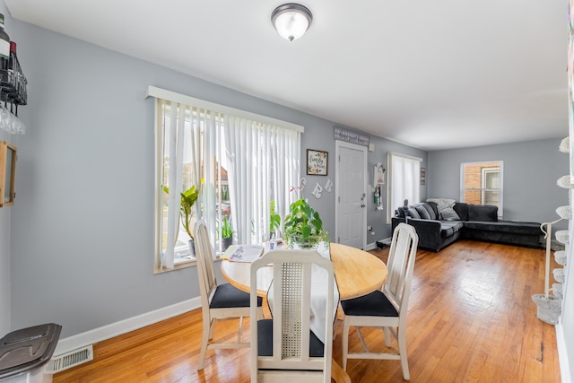 dining space with hardwood / wood-style floors