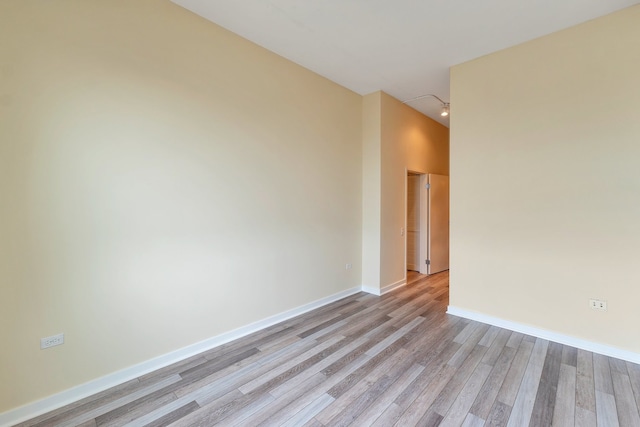 empty room with light hardwood / wood-style flooring