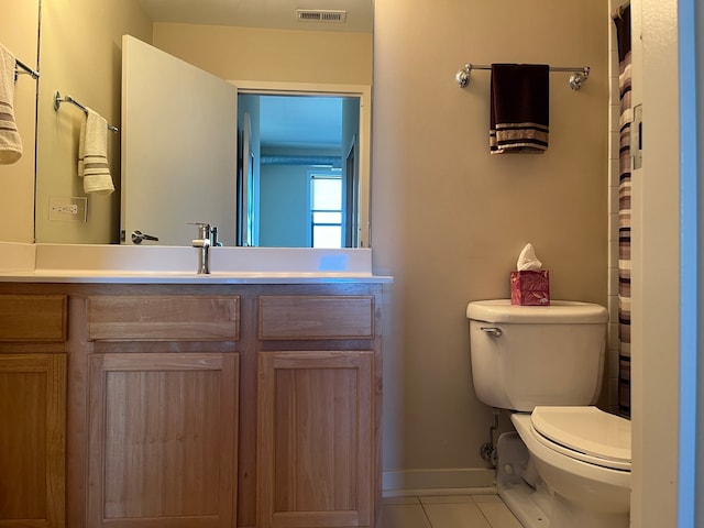 bathroom featuring tile patterned floors, vanity, and toilet