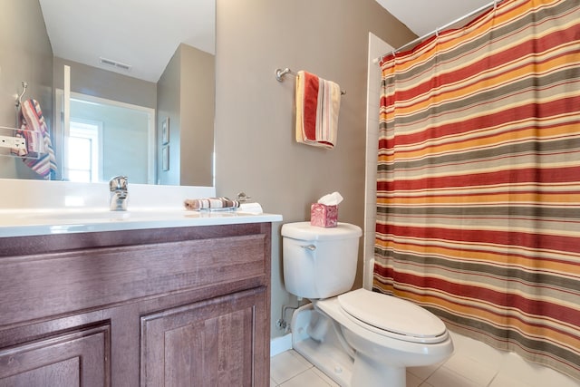 bathroom featuring walk in shower, vanity, toilet, and tile patterned floors