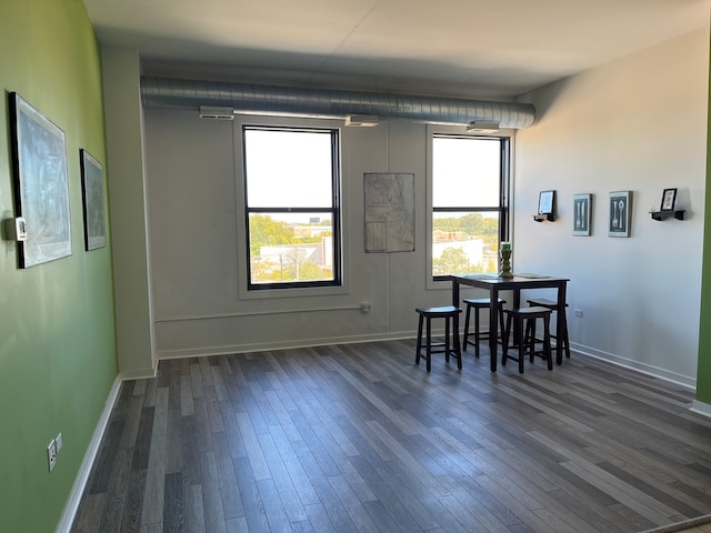 dining area featuring plenty of natural light and dark wood-type flooring