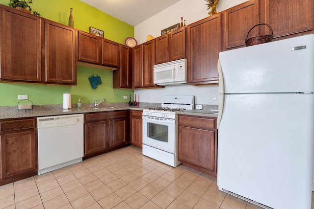 kitchen with light tile patterned floors, sink, and white appliances