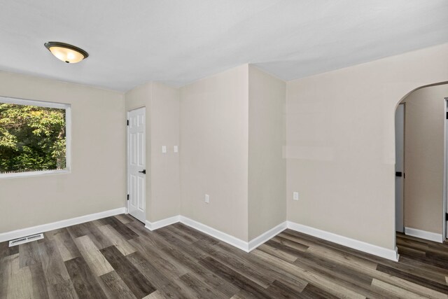 empty room with dark hardwood / wood-style floors