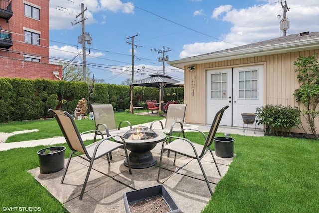 view of patio / terrace with a fire pit and a gazebo