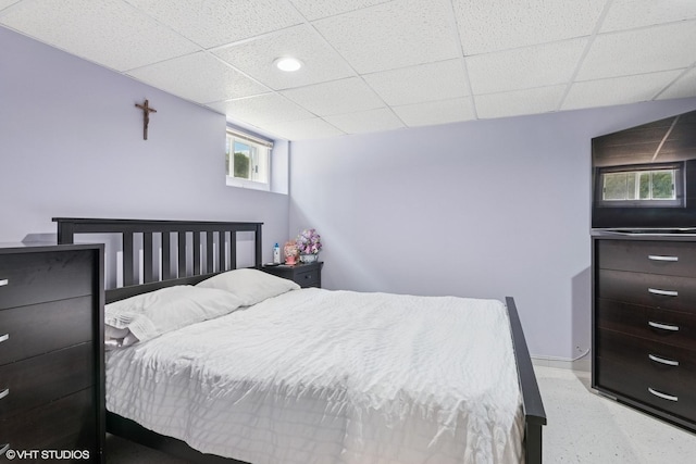 bedroom with baseboards, a drop ceiling, and recessed lighting