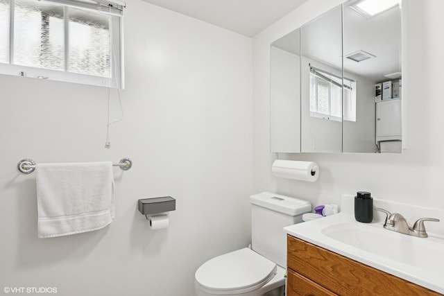 half bathroom featuring toilet and vanity