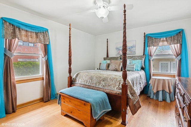 bedroom with light wood finished floors, ceiling fan, and baseboards