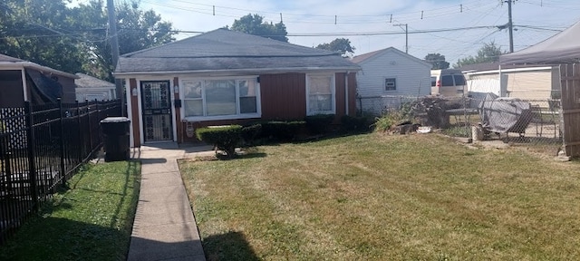 rear view of house with a lawn