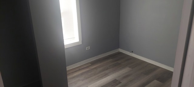 unfurnished room with hardwood / wood-style flooring