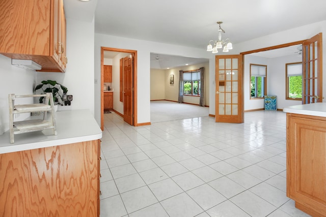 kitchen with hanging light fixtures, light tile patterned flooring, and a chandelier