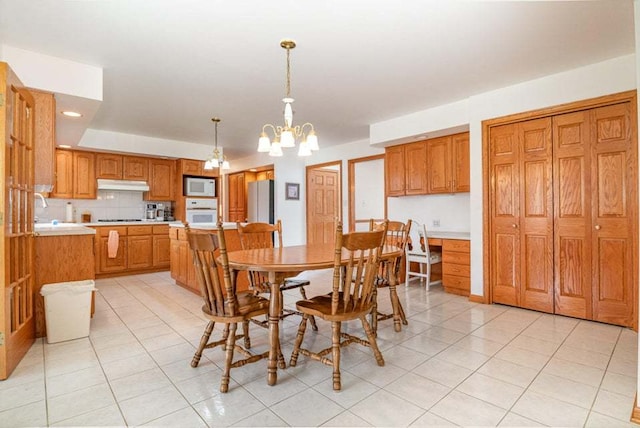 tiled dining area with a notable chandelier