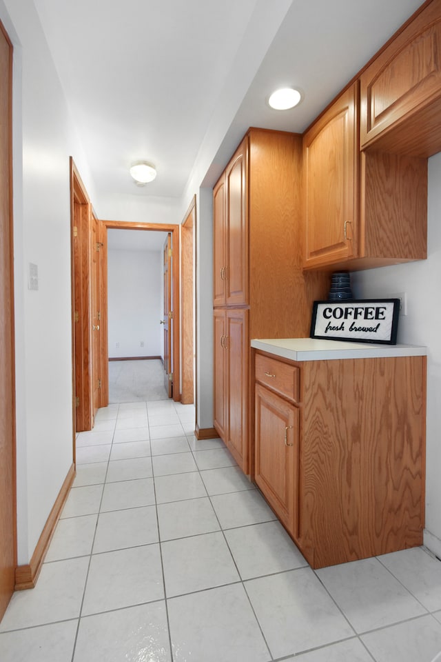 hall with light tile patterned floors