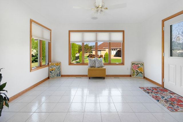 interior space featuring ceiling fan and light tile patterned floors