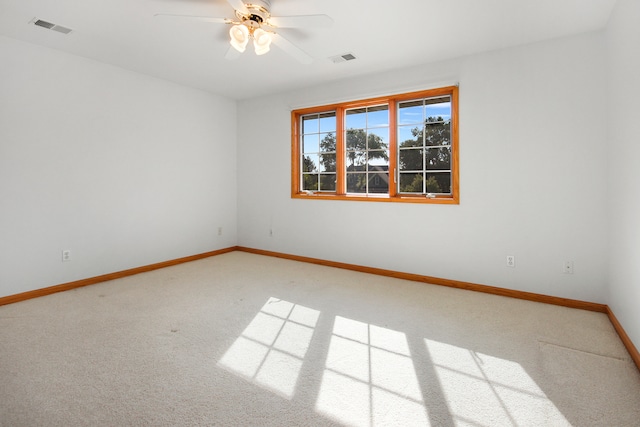 empty room featuring carpet floors and ceiling fan