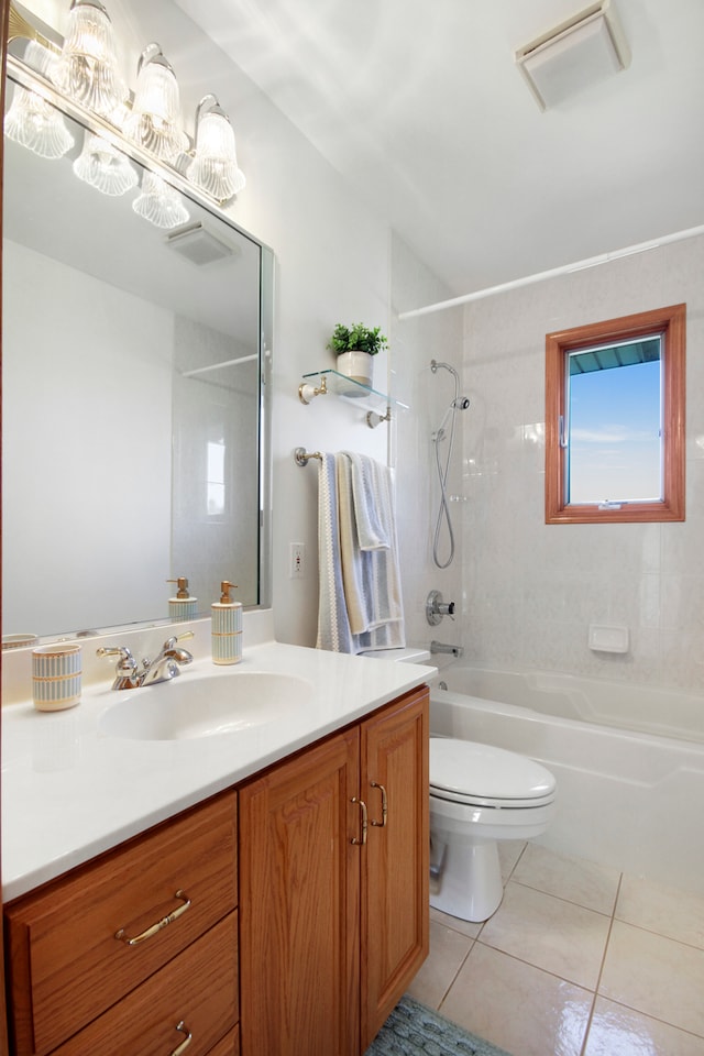 full bathroom featuring tile patterned floors, tiled shower / bath combo, vanity, and toilet