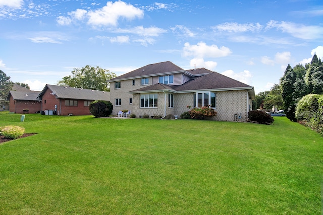 rear view of property with a yard