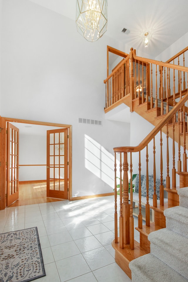 stairs featuring a notable chandelier and hardwood / wood-style floors