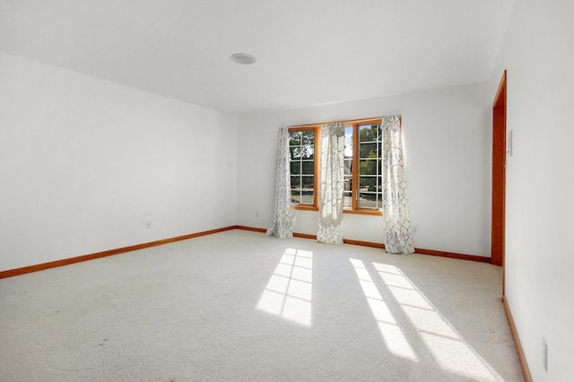 spare room with light colored carpet