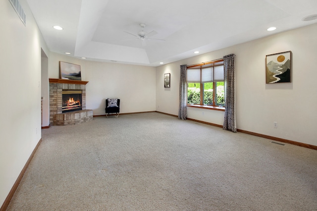 unfurnished living room with carpet flooring, ceiling fan, and a fireplace