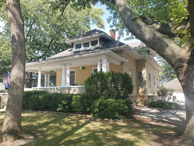 view of property exterior with a lawn