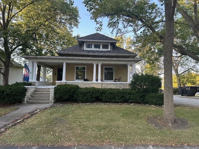 view of front of home featuring a porch and a front lawn