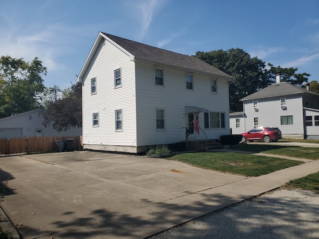 colonial home with a front lawn