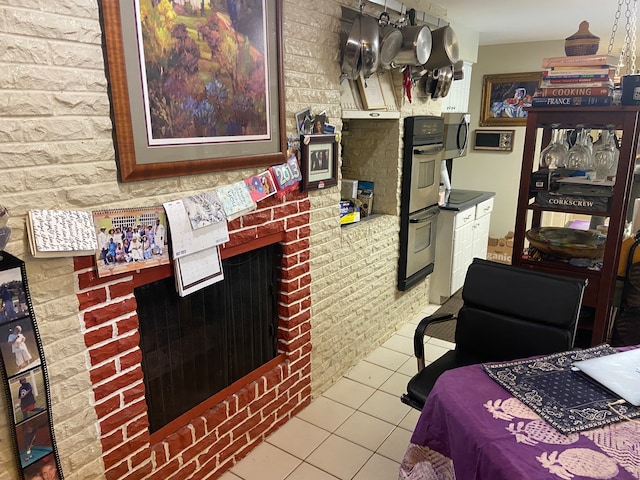 tiled bedroom with a fireplace and brick wall