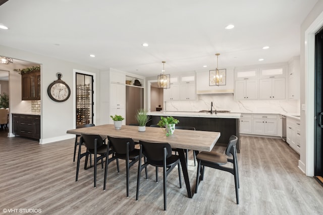 dining area with light wood-type flooring and sink