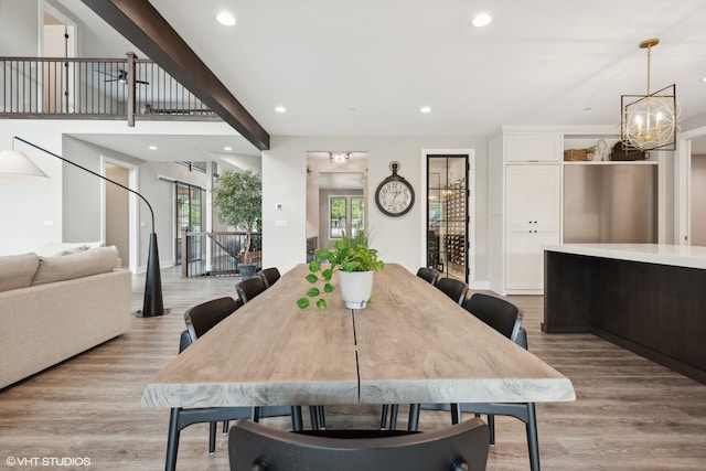 dining room featuring light hardwood / wood-style flooring and a notable chandelier