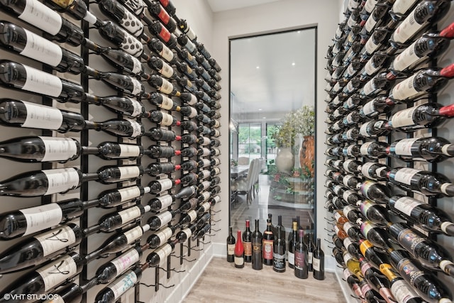 wine area with light hardwood / wood-style flooring