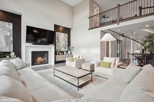 living room featuring wood-type flooring and a high ceiling