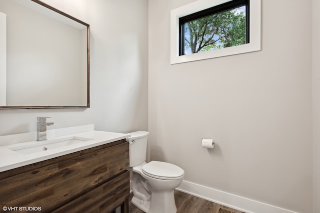 bathroom featuring hardwood / wood-style floors, vanity, and toilet