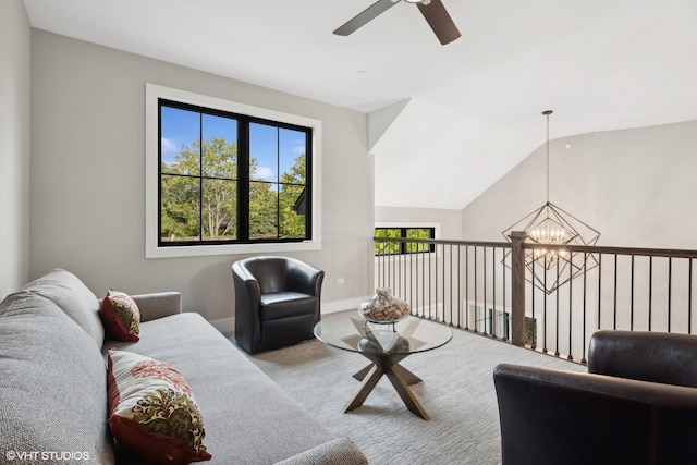 living room with carpet floors, ceiling fan with notable chandelier, plenty of natural light, and vaulted ceiling