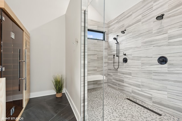 bathroom with lofted ceiling, tile patterned flooring, and an enclosed shower