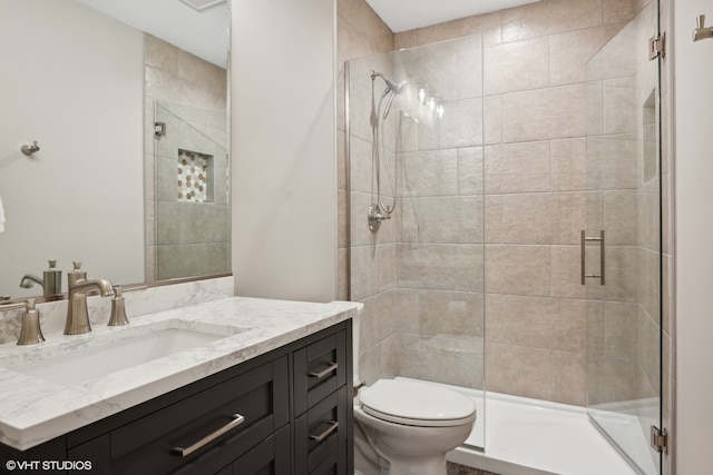 bathroom with vanity, toilet, and an enclosed shower