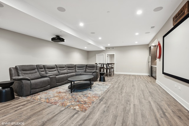 cinema featuring light hardwood / wood-style floors