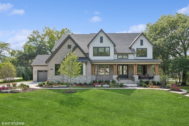 view of front of house with a garage, a porch, and a front lawn