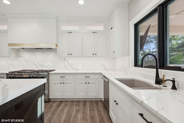 kitchen featuring light stone countertops, stainless steel appliances, backsplash, and white cabinetry