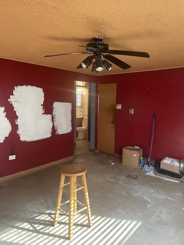 empty room featuring a textured ceiling and ceiling fan
