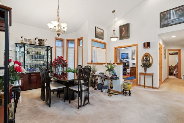 carpeted dining room featuring lofted ceiling and a notable chandelier