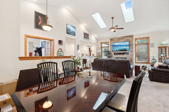 dining room featuring ceiling fan, light carpet, and high vaulted ceiling