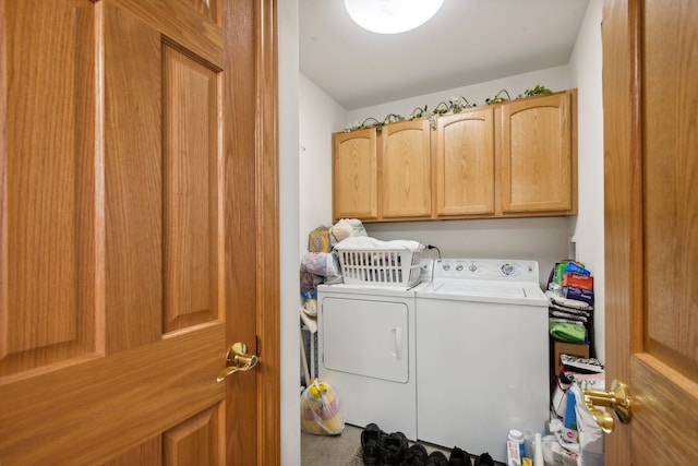 washroom featuring cabinets and independent washer and dryer